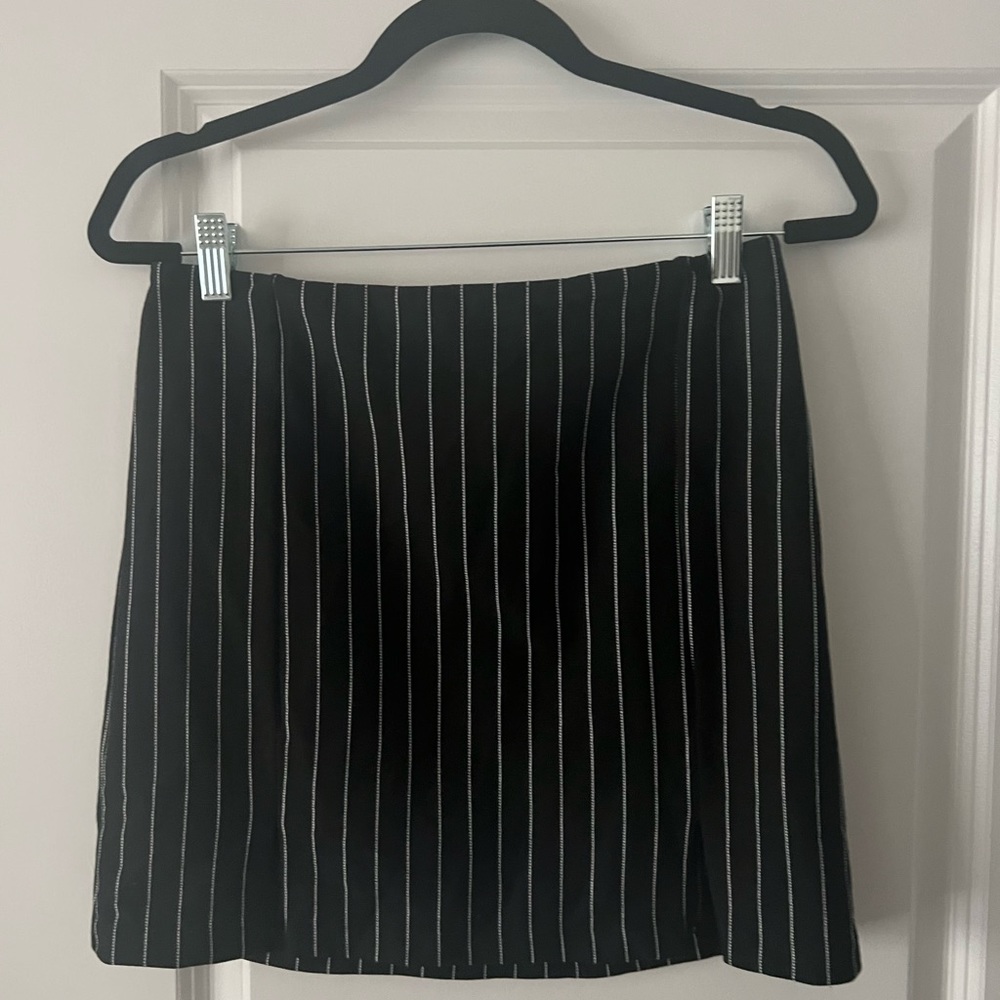 Black mini skirt with white stripes.